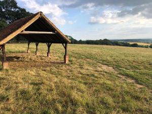 a small building in a field with a field at Penn Meadow Farm in Buckinghamshire