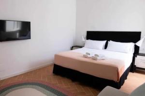 a bedroom with a bed and a flat screen tv at Suite 2 in Mahón