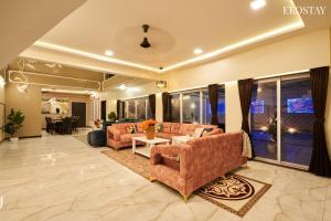 a living room with a couch and a table at EKOSTAY Luxe - Highland Villa in Panchgani