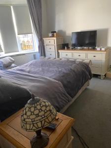 1 dormitorio con 1 cama y 1 mesa con lámpara en Holmhurst, en South Bank