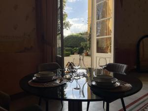 a dining room table with plates and glasses on it at Il Sogno di Elisa in Lucca +27 photos