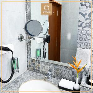 baño con espejo y lavabo en Otium Goa Resort by The Oterra, en Porvorim