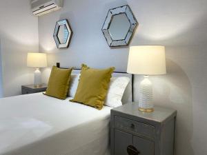 a bedroom with a bed with two mirrors on the wall at Centric Lovely private flat 2BD, 2BH + AC in Madrid