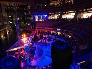 a crowd of people watching a concert in a building at Legatio Hakata Hotel in Fukuoka