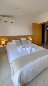 a large white bed with white pillows on it at Céntico y con Terraza in Terrassa