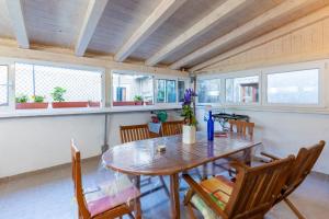 a dining room with a wooden table and chairs at Guesthouse Romana in Cres