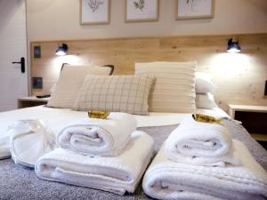 a bedroom with towels on a bed at Mon Cheri Clarens in Clarens