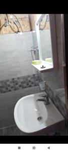a bathroom with a white sink and a mirror at Ada Bojana - Kucica Djakonovic in Ulcinj