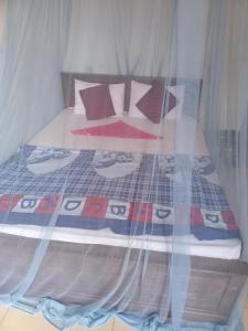 a bedroom with a bed with a comforter and pillows at Dreamscape home stay in Kandy