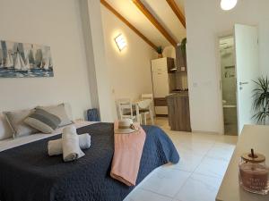 a bedroom with a bed with towels on it at Poolside Studio in Fažana