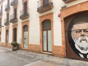 a mural of a man on the side of a building at PISO EN EL CENTRO DE HUELVA SILENCIOSO Y CON GRAN PATIO, Calle La Paz in Huelva