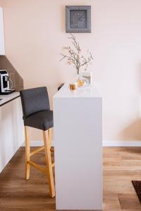 a white table and a chair in a kitchen at Apartament Bimba & Free Parking in Poznań