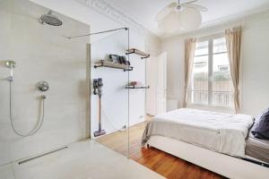 a white bedroom with a shower and a bed at JO - Appartement porte maillot Paris 16 - 4P in Paris
