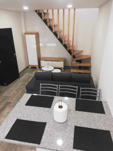 a living room with a couch and a staircase at Casa de São Miguel in Mirandela