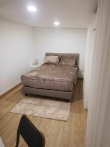 a bedroom with a bed in a white room at Casa de São Miguel in Mirandela