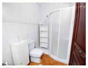a white bathroom with a toilet and a shower at Casa Tere in Benitachell +15 photos