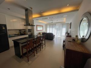 a kitchen and living room with a counter and a table at WERT in Phuket Town