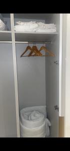 a small white closet with a toilet in it at Spacious apartment in Barking