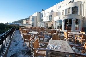 a row of tables and chairs in front of a building at The Foley Arms Hotel Wetherspoon in Great Malvern