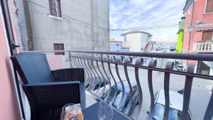 a balcony with a table and chairs on a balcony at Alicetta Apartment by Ca-Sa Check in Chioggia