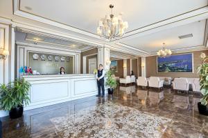 a man in a suit stands in the lobby of a hotel at Boulevard Side Hotel in Baku