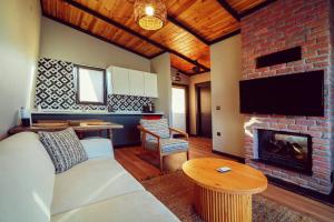 a living room with a couch and a fireplace at Vital Göl Sapanca Özel Havuzlu Bungalov & Villa in Sapanca