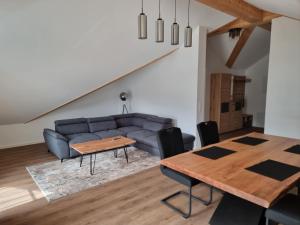 a living room with a couch and a table at Breitenbergerhof Pfronten in Pfronten