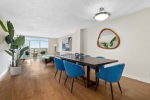 a dining room with a table and blue chairs at Ocean View Luxurious Retreat Full 3Bedroom Marina in Los Angeles