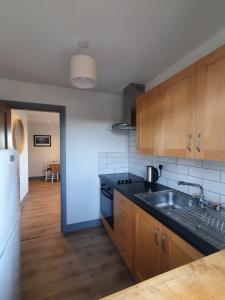 a kitchen with a sink and a stove at Roaringwater Stay in Skibbereen
