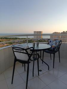 einen Tisch und Stühle auf einem Balkon mit Aussicht in der Unterkunft Laguna Suite & More in Porlamar