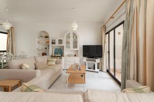 a living room with a couch and a tv at Great, Bright 2-bedroom Flat in the Center of Vilamoura -Topázio By Centralgarve in Vilamoura