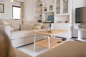 a living room with a couch and a table at Great, Bright 2-bedroom Flat in the Center of Vilamoura -Topázio By Centralgarve in Vilamoura