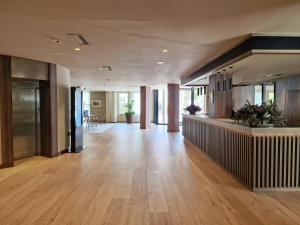 a large hallway with a hard wood floor and a lobby at Gran Hotel Balneario De Puente Viesgo in Puente Viesgo