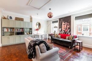 a living room with a couch and a table at 1BR Chic Covent Garden Retreat in London