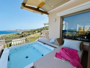 a hot tub on the balcony of a house at Bella Mare Sitia in Sitia