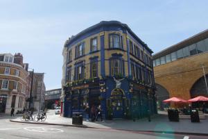 a large blue and yellow building on a city street at Tooley Street Apartments by Viridian Apartments in London