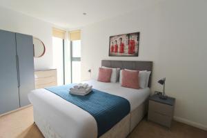 a bedroom with a large bed with a blue blanket at Tooley Street Apartments by Viridian Apartments in London