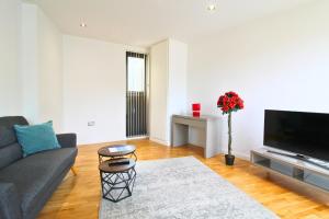 a living room with a couch and a tv at Tooley Street Apartments by Viridian Apartments in London