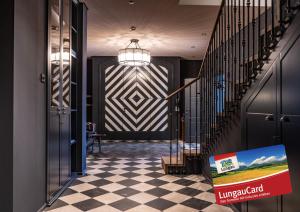 a hallway with a checkered floor and a staircase at HERBERT - Boutique Apartments inkl Lungau Card in Katschberghöhe
