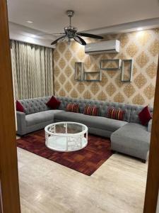 a living room with a couch and a coffee table at Kamz Homestay Chandigarh 35 in Chandīgarh