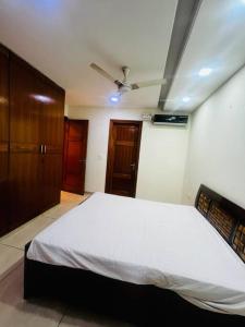 a bedroom with a bed and a ceiling fan at Kamz Homestay Chandigarh 35 in Chandīgarh