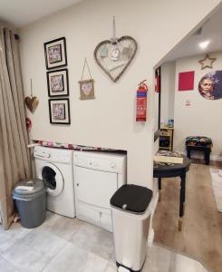 a laundry room with a washing machine and a table at Unboring Holiday Let, Ballina, Mayo in Ballina