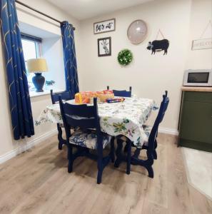 a dining room table and chairs with a table and a table at Unboring Holiday Let, Ballina, Mayo in Ballina
