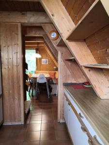 a kitchen with wooden ceilings and a dining room at Haus Paradiesecke in Waldbrunn