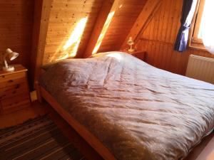 a bedroom with a bed in a wooden cabin at Haus Paradiesecke in Waldbrunn