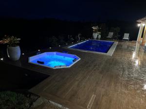 una piscina in un cortile posteriore di notte di @RanchoNoLago - Casa de Campo no Lago Corumba IV a Alexânia Altre 22 foto
