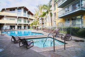 a swimming pool with chairs and a building at Ocean View Luxurious Retreat Full 3Bedroom Marina in Los Angeles