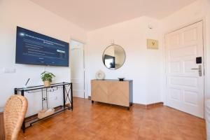 a room with a mirror on the wall and a table at Hygge Home with Seaside and Golf-View Balcony in San Miguel de Abona