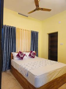 a bedroom with a bed with red pillows on it at Clive Ten Resorts Athirapilly in Kizhake Chālakudi +15 photos