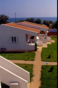 a house with a pathway leading up to it at Helonata Apartments in Arkoudi